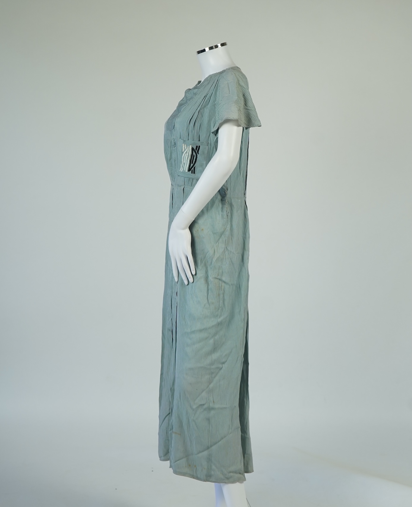 Two 1930's printed silk crepe summer day dresses together with a similar pale blue and black stripped summer day dress., Condition - the maroon and cream dress has damage to one sleeve, the green dress has worn under the
